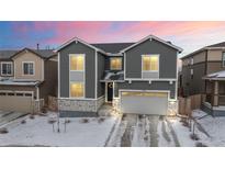 Charming two-story home featuring gray siding, stone accents, and a well-manicured front yard at 5088 S Quail St, Littleton, CO 80127