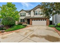 Charming two-story home featuring a brick-accented garage and a well-manicured front yard at 3151 E 134Th Cir, Thornton, CO 80241