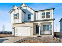 Charming two-story home showcasing white siding, brick accents, and a well-manicured front yard at 8950 Whiteclover St, Littleton, CO 80125