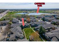 An aerial view showcases the property with Carpenter Park in the background at 3000 E 112 Ave # 102, Northglenn, CO 80233