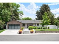 Charming single-story home with well-maintained landscaping, modern garage door, and inviting curb appeal at 2998 S Adams St, Denver, CO 80210