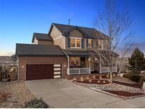 Charming two-story home with a well-manicured lawn, a brick-accented garage, and cozy front porch at 2345 Tavern Way, Castle Rock, CO 80104