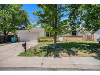 Charming single story home with a two car garage and mature trees at 16215 E Brunswick Dr, Aurora, CO 80013