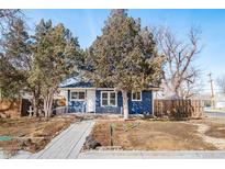 Charming blue single story house with mature landscaping and a sidewalk leading to the front door at 1195 Florence St, Aurora, CO 80010