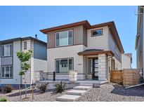 Charming two-story home with modern architectural design and a well-manicured front yard at 10557 Eby Cir, Lone Tree, CO 80124