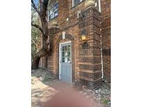 Charming brick building entrance featuring a classic address plaque and exterior lighting at 1024 E 14Th Ave # 2, Denver, CO 80218