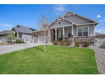 Charming home with a manicured lawn and a welcoming front porch at 8852 Farmdale St, Firestone, CO 80504