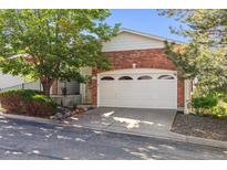 Exterior features a brick front, two-car garage, and well maintained landscaping at 1878 S Cole St, Lakewood, CO 80228