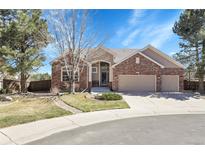 Charming brick home featuring a three-car garage and beautifully landscaped front yard at 10145 Joseph Dr, Highlands Ranch, CO 80130