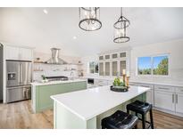 Bright kitchen features two islands, stainless steel appliances, and stylish pendant lighting at 10694 Camelot Dr, Franktown, CO 80116