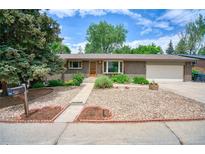 Charming brick ranch home with a manicured front yard and inviting entrance at 1607 Ulysses St, Golden, CO 80401