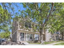Inviting townhouse with stone accents and lush trees creating a warm, neighborhood feel at 1325 S Idalia St, Aurora, CO 80017