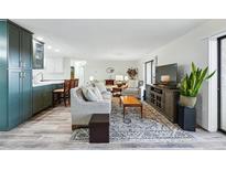 Bright living room features modern décor and an open layout connecting to the kitchen at 13850 E Marina Dr # 606, Aurora, CO 80014