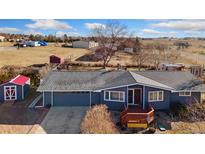 Charming ranch-style home featuring a spacious yard and inviting front porch at 200 Bothun Rd, Berthoud, CO 80513