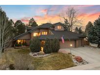 Stunning exterior view of a home showcasing its unique architecture and lush landscaping at sunset at 5034 E Otero Cir, Centennial, CO 80122
