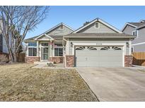 Charming single-Gathering home featuring a well-manicured lawn and an attached two-car garage at 6508 Moss Cir, Arvada, CO 80007