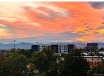 Beautiful sunset view over the city buildings and distant mountains, creating a vibrant and serene atmosphere at 300 W 11Th Ave # 4F, Denver, CO 80204