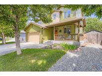 Charming two-story home featuring a welcoming front porch and well-maintained landscaping at 676 Hedgerow Way, Brighton, CO 80601