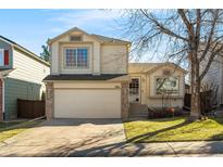 Charming two-story home featuring an attached two-car garage, manicured lawn, and welcoming front entrance at 9741 Moss Rose Cir, Highlands Ranch, CO 80129