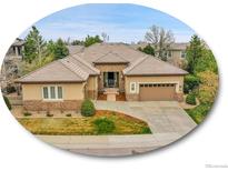 Inviting single-Gathering home with manicured lawn, tile roof, and a two-car garage at 2571 Hunters Pl, Highlands Ranch, CO 80129