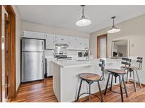 Bright kitchen features stainless steel appliances, ample countertop space, and a breakfast bar with stool seating at 24 Ski Pole Ct, Breckenridge, CO 80424
