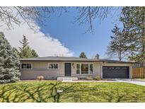 Charming, well-maintained single-story home with a tidy front yard, mature trees and painted brick facade at 3576 S Holly St, Denver, CO 80237