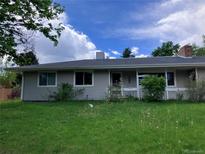 Charming one-story home with a well-maintained lawn and mature trees in a residential neighborhood at 3910 E Orchard Rd, Centennial, CO 80121