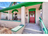 Charming front porch area with seating and red door with green trim at 2215 Meade St, Denver, CO 80211