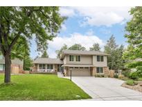 Charming two-story home with a well-manicured lawn, neutral siding, stone accents and an attached two-car garage at 4680 W 100Th Ave, Westminster, CO 80031