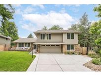 Charming two-story home with a well-manicured lawn and beautiful landscaping, featuring a stone-accented facade and a spacious driveway at 4680 W 100Th Ave, Westminster, CO 80031