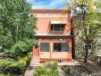 Charming brick home featuring a cozy front porch and well-maintained landscaping, located at 1258 at 1258 N Downing St, Denver, CO 80218