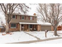 Two-story house with brick and siding exterior, covered porch, and attached garage at 360 S 30Th Ave, Brighton, CO 80601