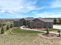 Stunning home with beautiful stone accents, landscaped yard, and pristine walkway at 5195 Raintree Cir, Parker, CO 80134