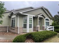 Charming single-story home with a well-maintained lawn and beautiful landscaping at 14400 Albrook Dr # 88, Denver, CO 80239