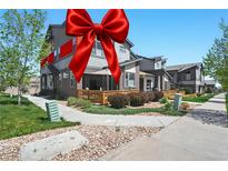 Charming townhome with a well-manicured lawn and inviting outdoor patio space, perfect for relaxation and entertaining at 12497 W Virginia Ave, Lakewood, CO 80228