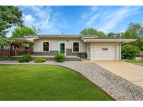 Charming single story home with manicured lawn, rock landscaping, and one-car attached garage at 1202 9Th Ave, Longmont, CO 80501