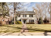 Charming two-story home with landscaped yard, symmetrical design, and classic architectural details at 5555 E 17Th Avenue Pkwy, Denver, CO 80220