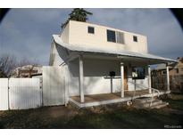 Charming home featuring a welcoming front porch and a fenced yard for added privacy and curb appeal at 3355 S Logan St, Englewood, CO 80113
