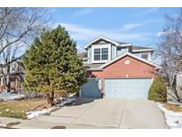 Two-story brick home with attached two-car garage and landscaping at 458 Whitetail Cir, Lafayette, CO 80026