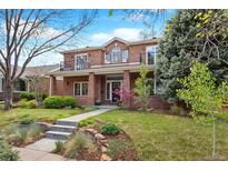 Beautiful two-story brick home with manicured front yard and inviting walkway at 1215 S Ogden St, Denver, CO 80210