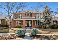 Charming two-story brick home with landscaped yard, columns, and upper-level balconies at 1215 S Ogden St, Denver, CO 80210