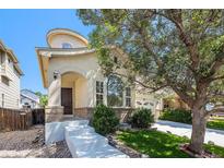 Charming stucco home with arched entry, large windows, mature trees, and well-manicured lawn in a desirable neighborhood at 9735 E 112Th Pl, Commerce City, CO 80640