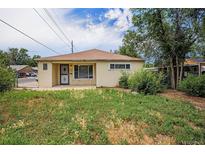 Exterior shot of a one-story home with a small yard and covered front porch area at 1303 Havana St, Aurora, CO 80010