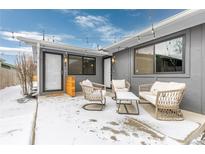 Cozy patio area with stylish furniture, string lights, and gray exterior, perfect for outdoor relaxation in a winter setting at 47 S Hazel Ct, Denver, CO 80219