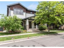 Charming two-story home with landscaped front yard, covered porch, and stone accents at 3858 W 117Th Ct, Westminster, CO 80031