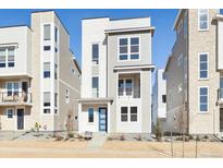 Modern three-story home with a blue front door and contemporary design at 1269 Penner Dr, Erie, CO 80026