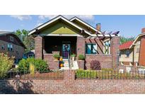 Brick home with charming front porch and landscaping at 3041 W 40Th Ave, Denver, CO 80211