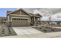 Charming single-Gathering home featuring a two-car garage and low maintenance xeriscape in front yard at 483 Agoseris Way, Castle Rock, CO 80104