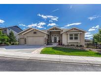 Charming single-story home featuring a well-manicured lawn, stone accents, and a three-car garage at 16192 St Lawrence Way, Monument, CO 80132