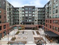 Wonderful exterior shot of Encore, a modern apartment complex with an inviting courtyard and upscale shops at 20 Wilcox St # 302, Castle Rock, CO 80104